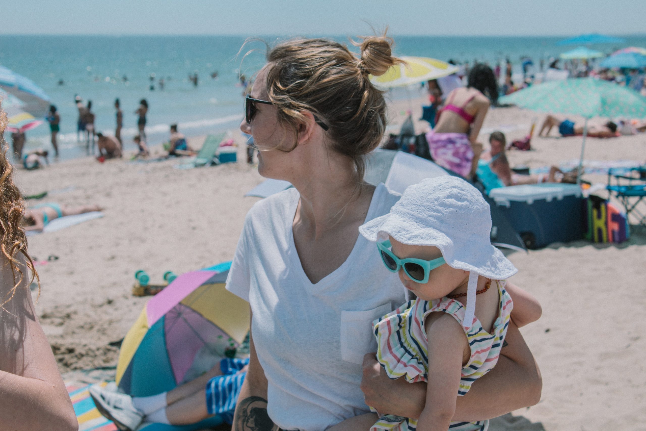 woman holding a baby in the beach